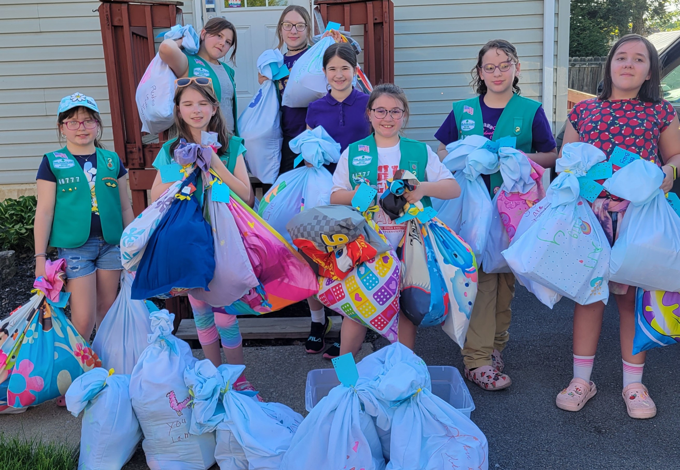 Junior Girl Scouts from Troop # 46777 created 30 care packages for children impacted by domestic violence while earning their Bronze Award, the third highest award in Girl Scouts of the USA.  Delivering the care packages are:  Lydia Geist, Serena Elbel, Jaysa Barenchik, Bailey Schneider, Isabella Valkosky, Danielle Davis, Abigail Richards, and Anna Bishop.  Missing from the photo is Bailey Griffith.